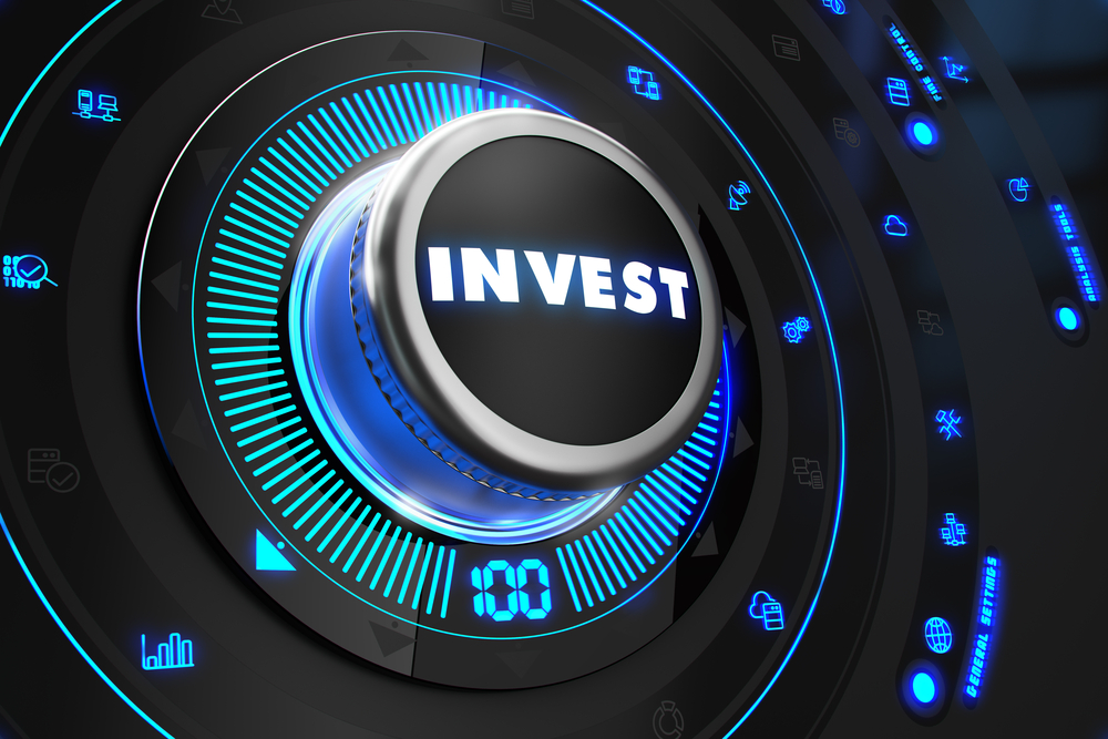 Invest Regulator on Black Control Console with Blue Backlight. Improvement, regulation, control or management concept. Invest Regulator on Black Control Console with Blue Backlight. Improvement, regulation, control or management concept.